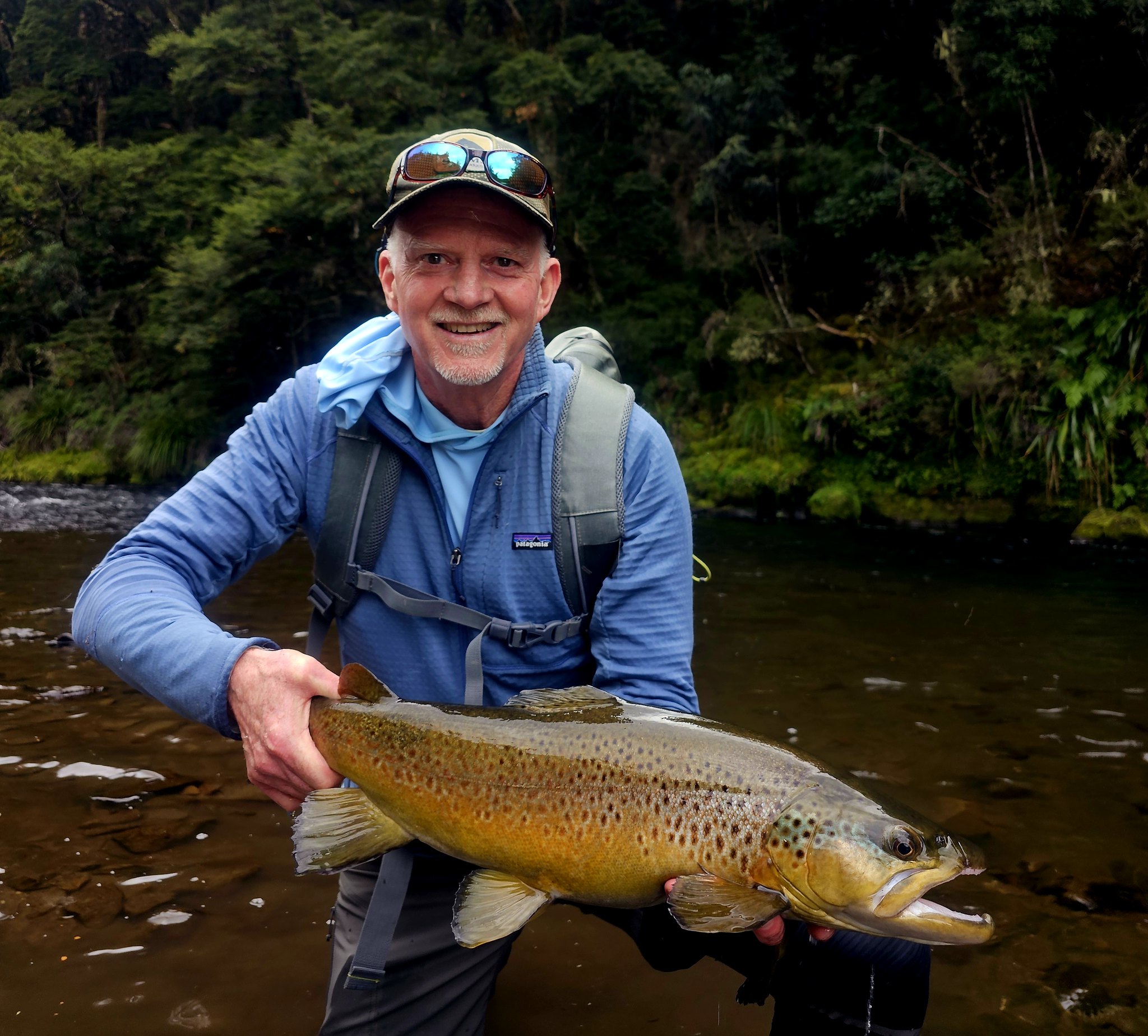 happy fisherman holding a fish